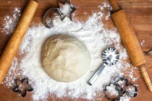 forms for squeezing the dough. dough on the table with dough tools. photo