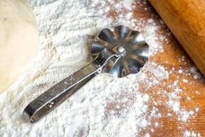 forms for squeezing the dough. dough on the table with dough tools. photo