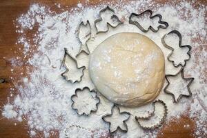 forms for squeezing the dough. dough on the table with dough tools. photo