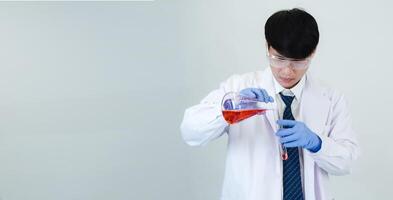 Portrait asian man student scientist or doctor look hand holding reagent mixing laboratory in science research laboratory with test tubes of various size in laboratory chemistry lab white background photo