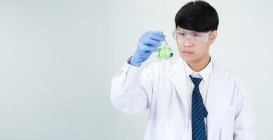 Portrait asian man student scientist or doctor look hand holding reagent mixing laboratory in science research laboratory with test tubes of various size in laboratory chemistry lab white background photo