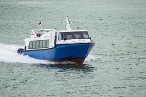 Batam, Indonesia - 8 July 2024. view of a passenger speed boat traveling fast photo