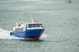 Batam, Indonesia - 8 July 2024. view of a passenger speed boat traveling fast photo