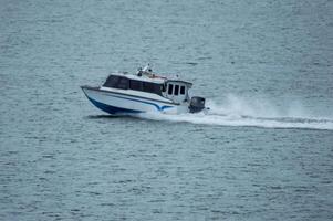 Batam, Indonesia - 8 July 2024. view of a passenger speed boat traveling fast photo