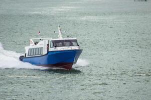 Batam, Indonesia - 8 July 2024. view of a passenger speed boat traveling fast photo