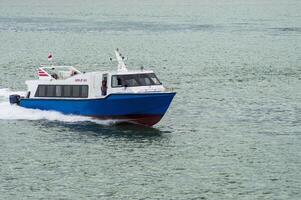 Batam, Indonesia - 8 July 2024. view of a passenger speed boat traveling fast photo