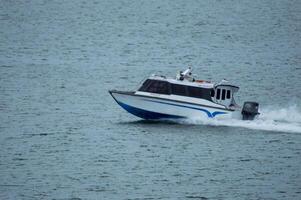 Batam, Indonesia - 8 July 2024. view of a passenger speed boat traveling fast photo