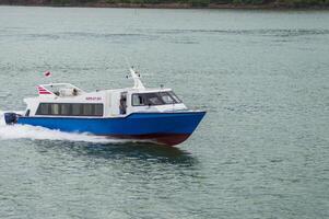 Batam, Indonesia - 8 July 2024. view of a passenger speed boat traveling fast photo