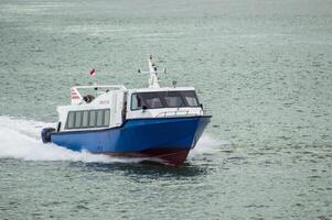 Batam, Indonesia - 8 July 2024. view of a passenger speed boat traveling fast photo