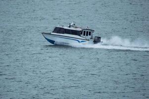 Batam, Indonesia - 8 July 2024. view of a passenger speed boat traveling fast photo
