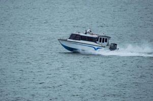 Batam, Indonesia - 8 July 2024. view of a passenger speed boat traveling fast photo