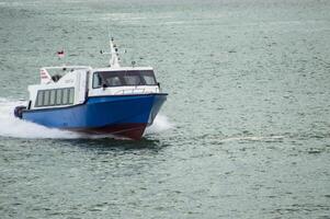 Batam, Indonesia - 8 July 2024. view of a passenger speed boat traveling fast photo