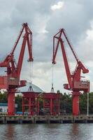 Batam, Indonesia. 7 July 2024. Grab crane, a tool used for loading and unloading cargo from ships. photo
