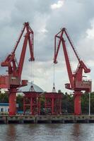 Batam, Indonesia. 7 July 2024. Grab crane, a tool used for loading and unloading cargo from ships. photo