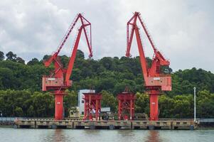 Batam, Indonesia. 7 July 2024. Grab crane, a tool used for loading and unloading cargo from ships. photo