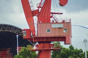 Batam, Indonesia. 7 July 2024. Grab crane, a tool used for loading and unloading cargo from ships. photo