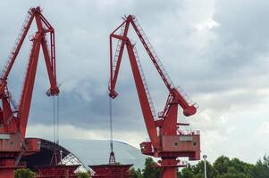 Batam, Indonesia. 7 July 2024. Grab crane, a tool used for loading and unloading cargo from ships. photo
