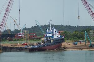 Batam, Indonesia. June 29, 2024. the process of raising the tugboat to the docx where maintenance will be carried out photo