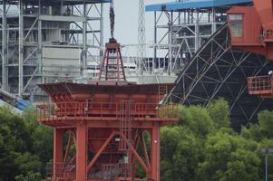 Batam, Indonesia. 7 July 2024. Grab crane, a tool used for loading and unloading cargo from ships. photo