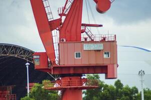 Batam, Indonesia. 7 July 2024. Grab crane, a tool used for loading and unloading cargo from ships. photo