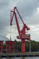 Batam, Indonesia. 7 July 2024. Grab crane, a tool used for loading and unloading cargo from ships. photo