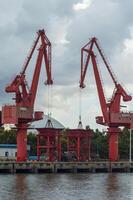 Batam, Indonesia. 7 July 2024. Grab crane, a tool used for loading and unloading cargo from ships. photo