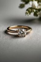 an elegant diamond engagement ring with a prominent solitaire, set on a slender gold band. The textured grey background adds a touch of sophistication photo