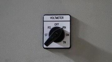 Close-Up of Voltmeter Selector Switch on Gray Panel with Multiple Settings in Industrial Setting photo
