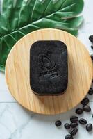 Top view Coffee bean soap bar as homemade, show word meaning natural 100 percentage on white table photo