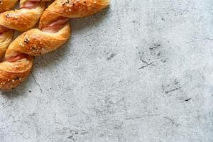 Homemade bacon bread twists on stone background, space for texture photo