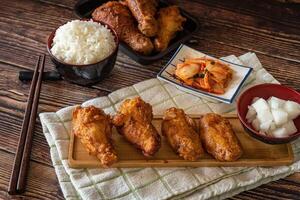 Korean fried chicken with garlic sauce and kimchi, drumstick and wings for menu photo