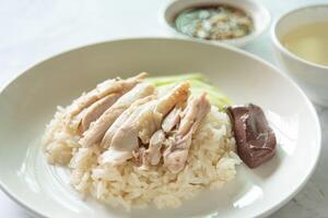 Hainanese Chicken rice with salted soya beans sauce and soup photo