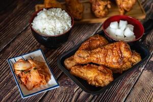 Korean fried chicken with garlic sauce and kimchi, drumstick and wings for menu photo