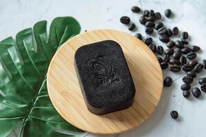 Natural hand soap bar with coffee as show word meaning natural 100 percentage on white table photo