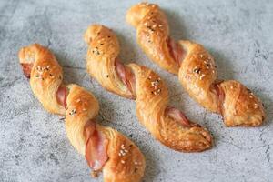 Homemade bacon bread twists on stone background, space for texture photo