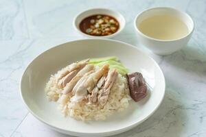 Closed up Chicken rice as Singapore street food with salted soya beans sauce and soup photo
