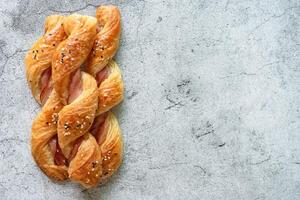 Homemade bacon bread twists on stone background, space for texture photo