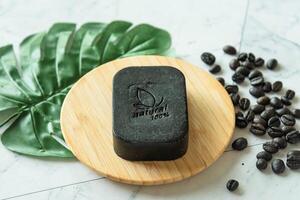 Coffee bean soap bar as homemade, show word meaning natural 100 percentage on white table photo