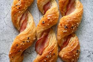 Homemade bacon bread twists on stone background, space for texture photo