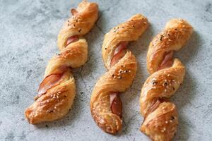 Homemade bacon bread twists on stone background, space for texture photo
