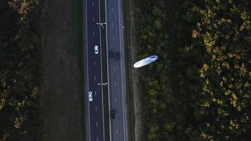 A bird's eye view of an engine-powered paraglider over a highway video