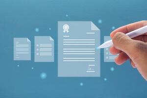Hand holding a pen with virtual screen of document. Digital document management and signing business contract concept. photo