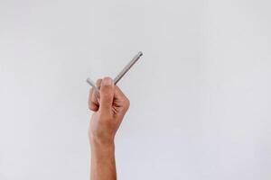 Hand holding an allen key or hex key or allen wrench isolated on white background photo
