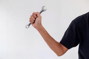Man holding a wrench or spanner on a white background photo