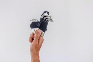Hand holding a set of allen key or hex key or allen wrench isolated on white background photo