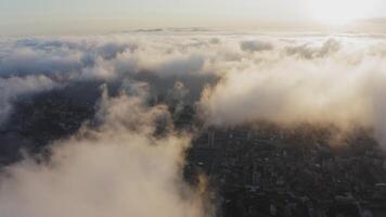 View from a drone of city center, above which clouds are rapidly floating video
