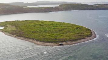 Drone view of the island with a beached wooden fishing schooner video