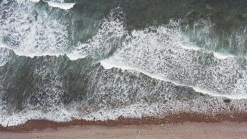 A view of the ocean and waves crashing against the rocky shore with white foam video