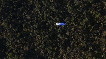 Drone captures paraglider flying over a highway from above video