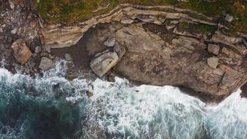 Aerial view of the picturesque high coastline, sharp cliffs and raging sea video